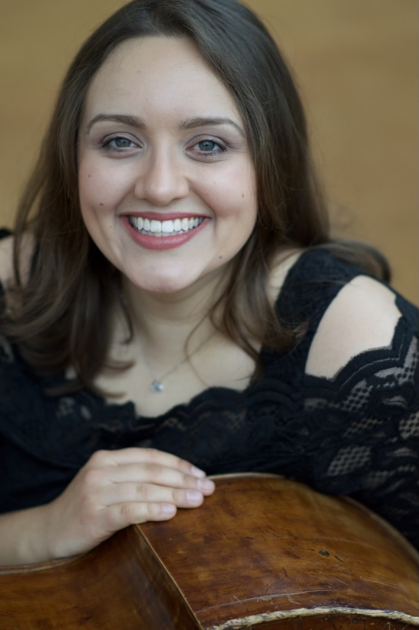 Kate Alexandra leaning on her double bass